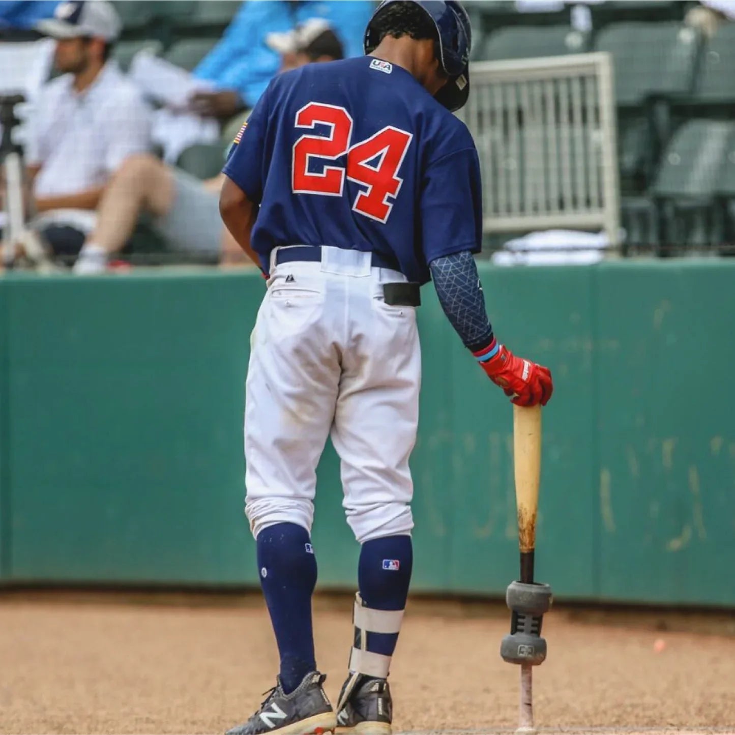 Baseball player demonstrating exit velocity training with a weighted bat