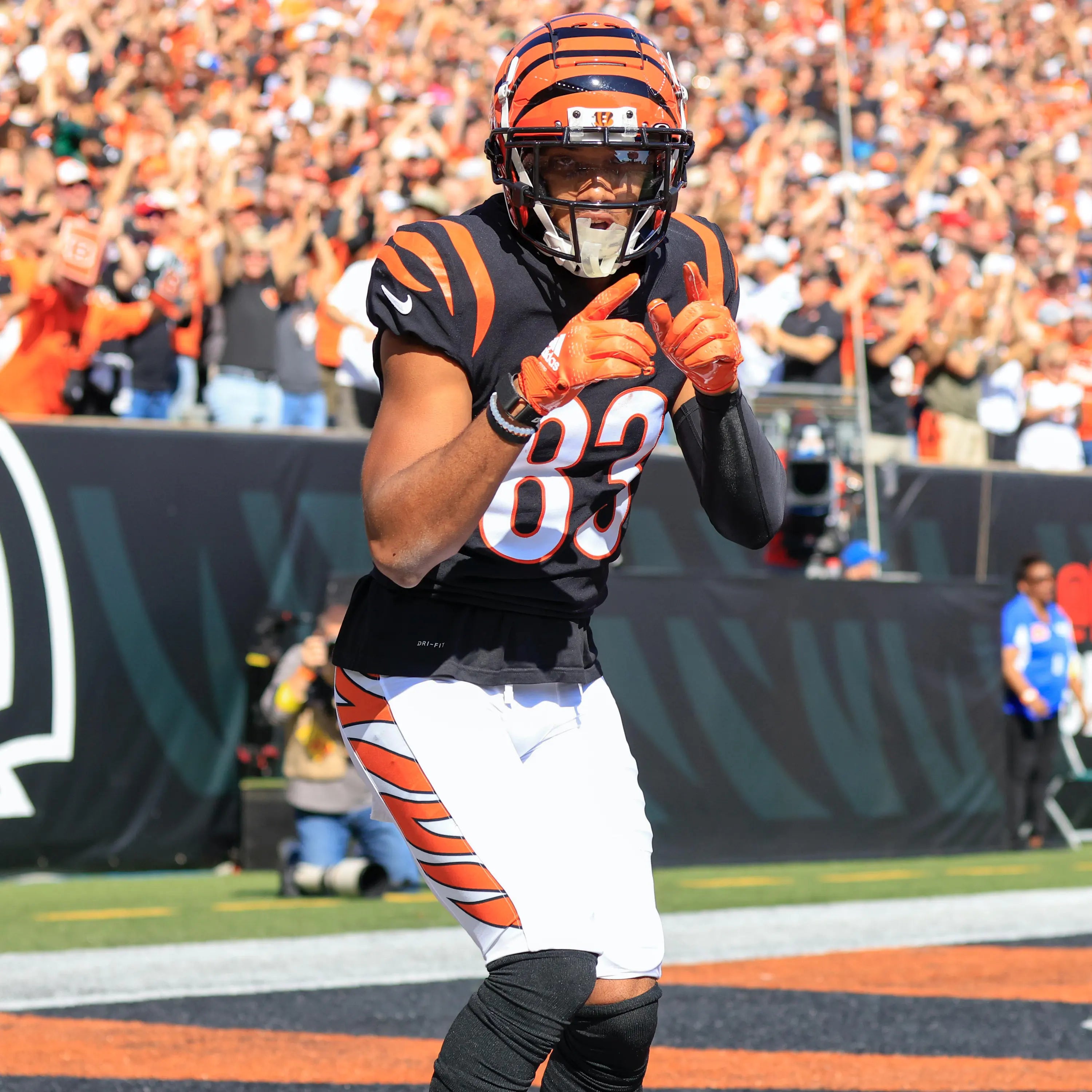 Running back securing a football to prevent fumbles — ball security drills, four-point contact technique, and grip gear from Vettex Sports