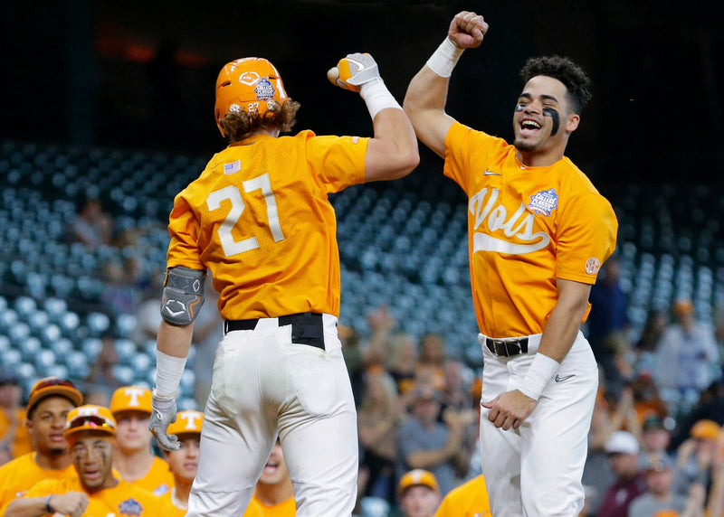 College baseball players celebrating on the field